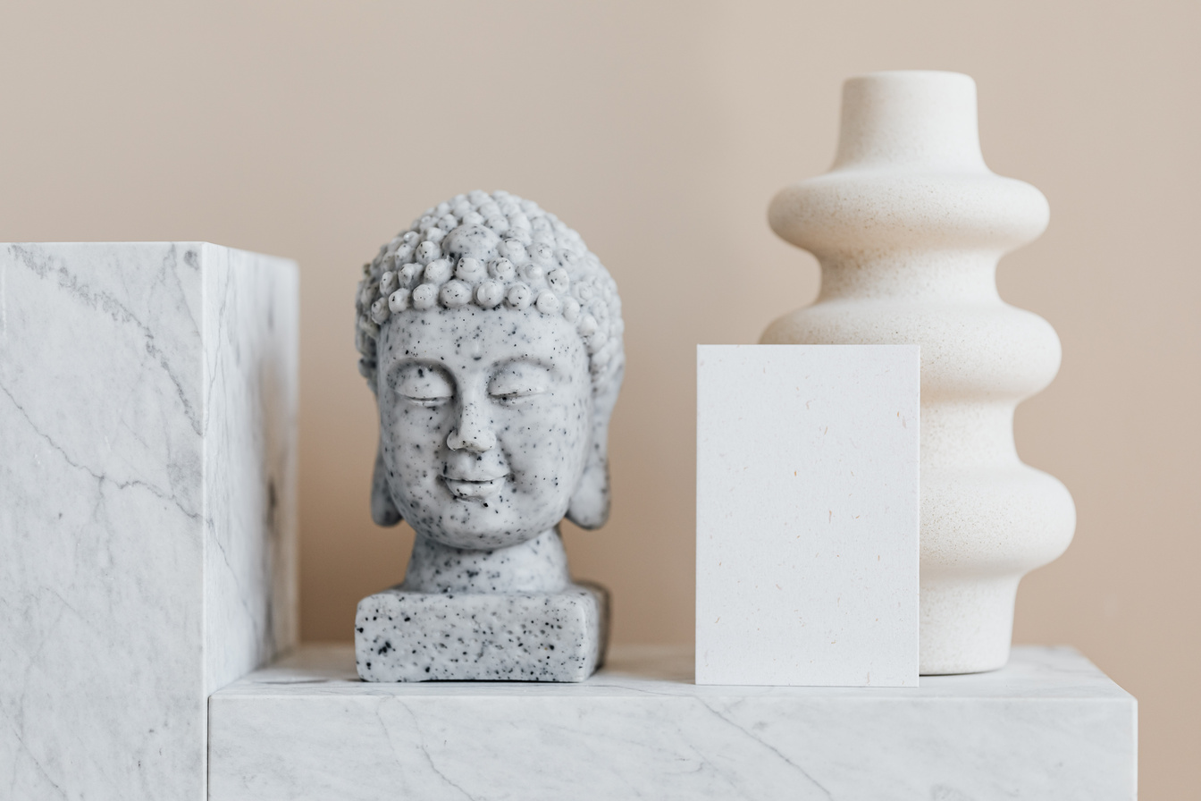 Home decoration composition with Buddha head and creatively shaped vase